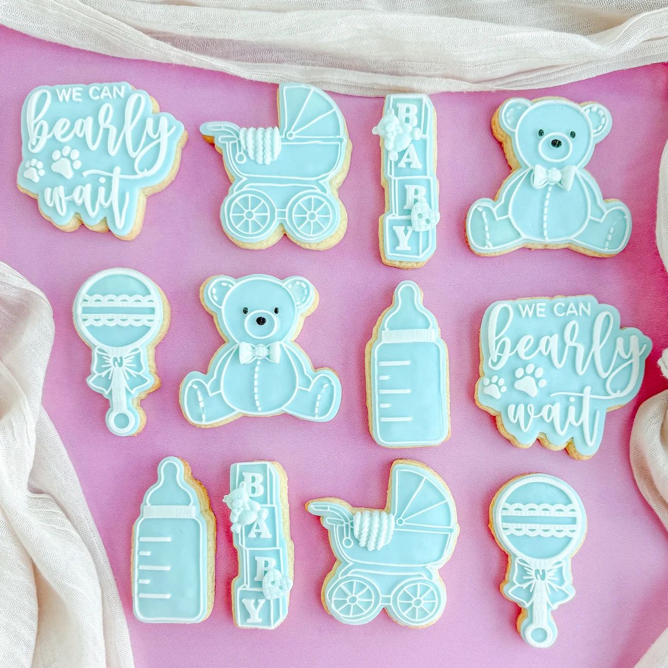 Hand-decorated blue teddy bear cookies for a baby shower